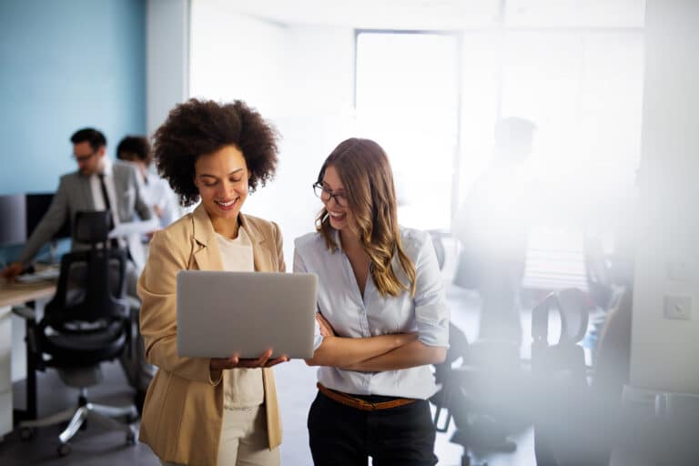 Happy multiethnic smiling business women working together in office